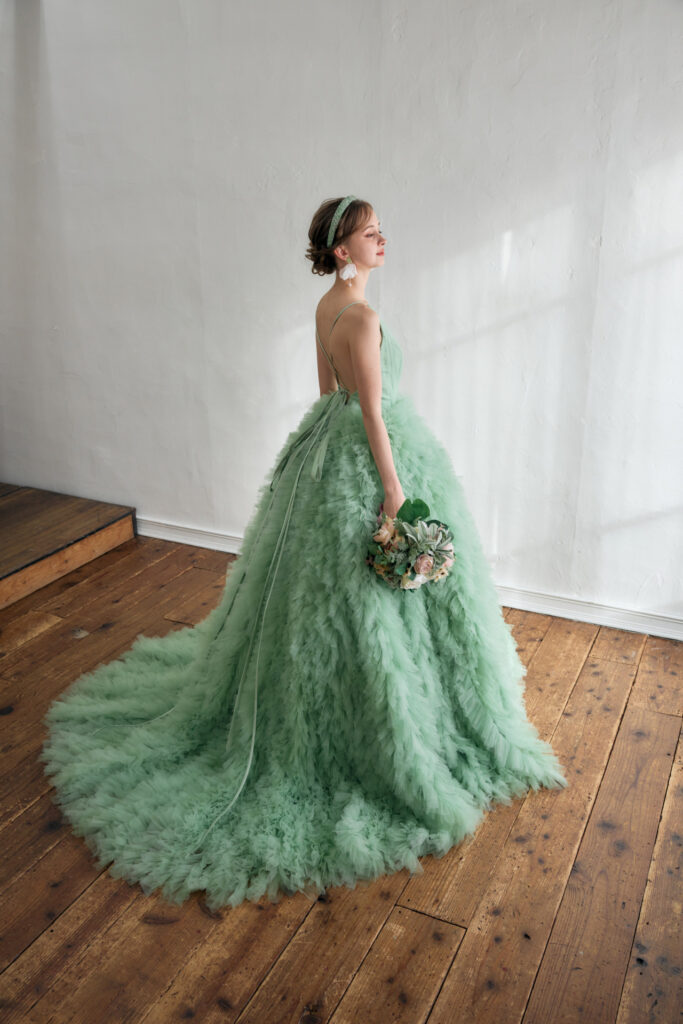 チュールが広がるグリーンのふわふわカラードレス全身写真。